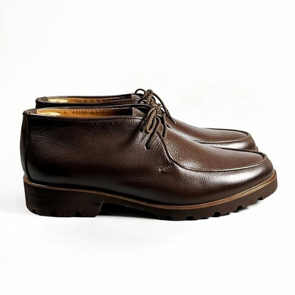 Men’s dark brown leather chukka shoes with lace-up design on white background