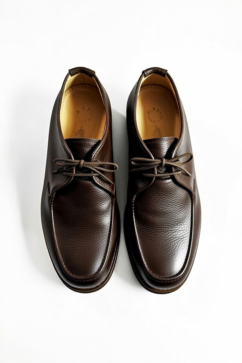 Men’s dark brown leather chukka shoes with lace-up design on white background