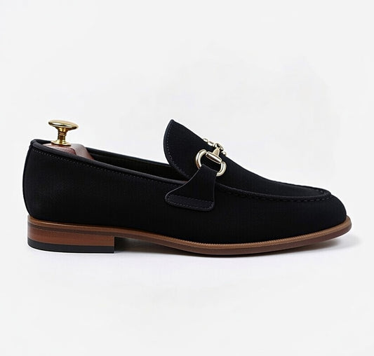 Men’s black leather horsebit loafers with gold buckle on white background