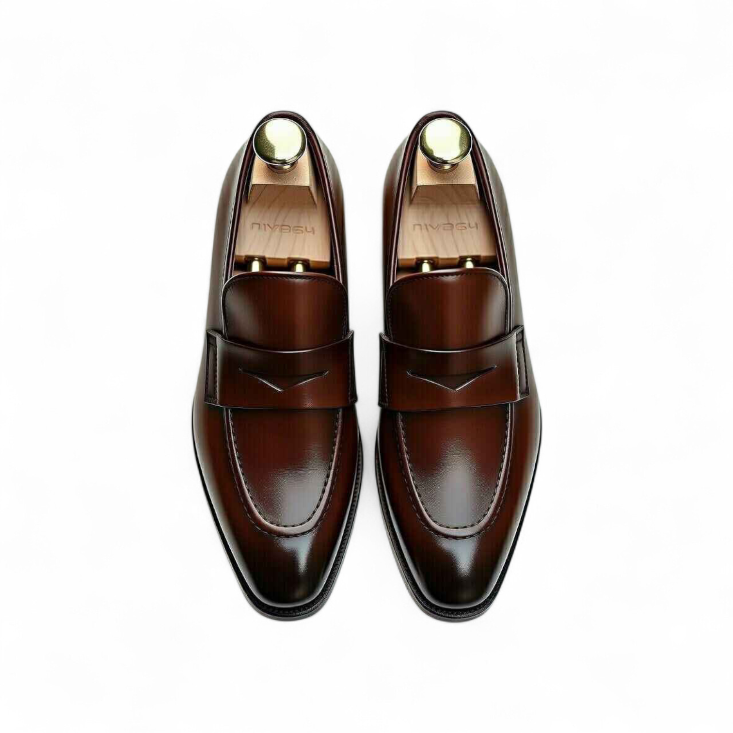 Pair of brown leather loafers on a white background