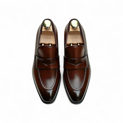 Pair of brown leather loafers on a white background