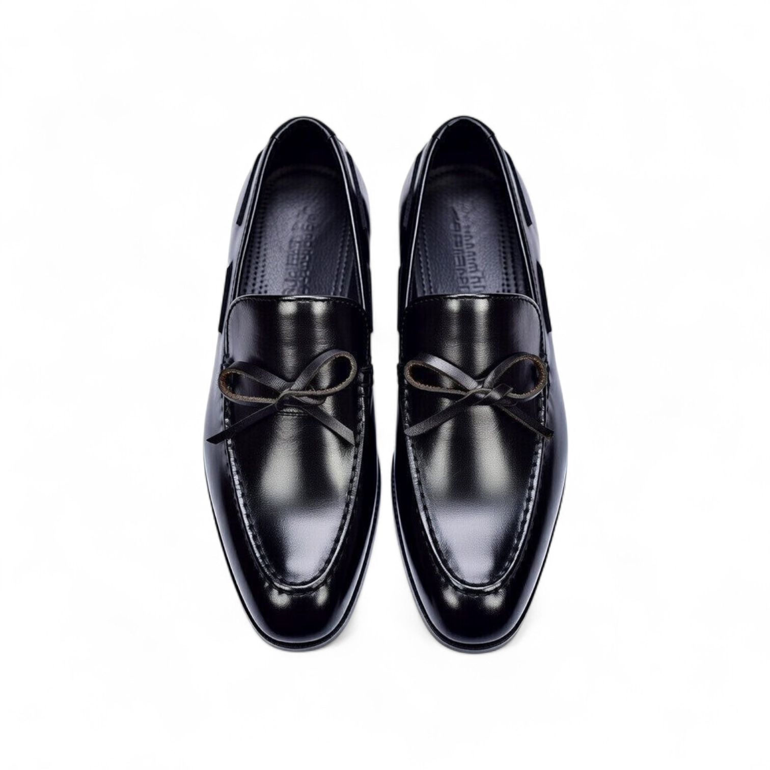 Pair of black dress shoes with brown laces on a white background
