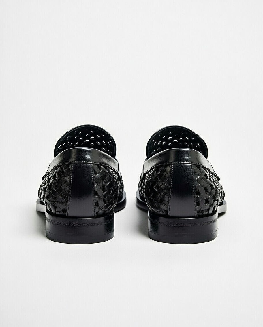 Black woven loafers on a white background