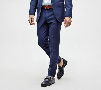 Person wearing a blue suit with black shoes on a light gray background