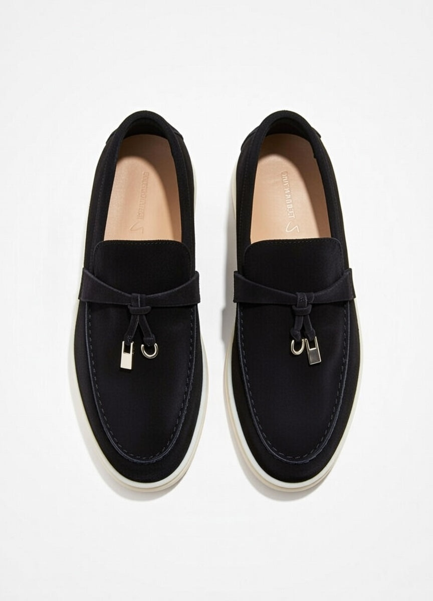 Pair of black loafers on a light gray background