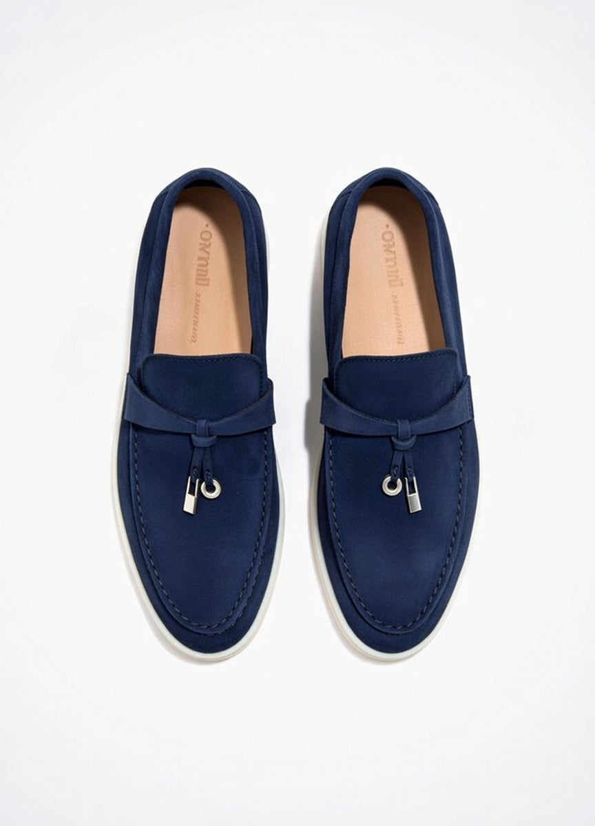 Pair of navy blue loafers on a white background