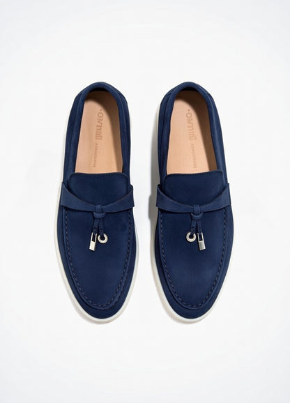 Pair of navy blue loafers on a white background