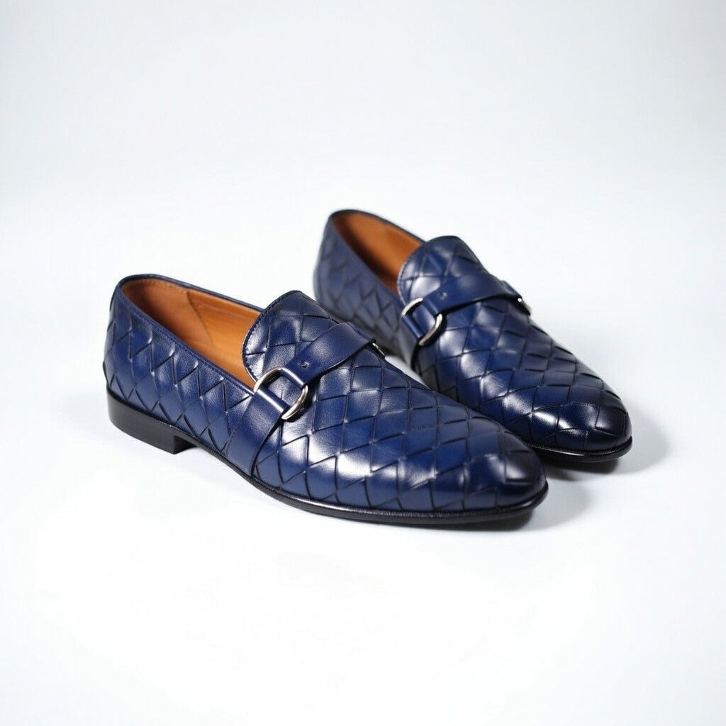 Pair of blue woven loafers on a white background