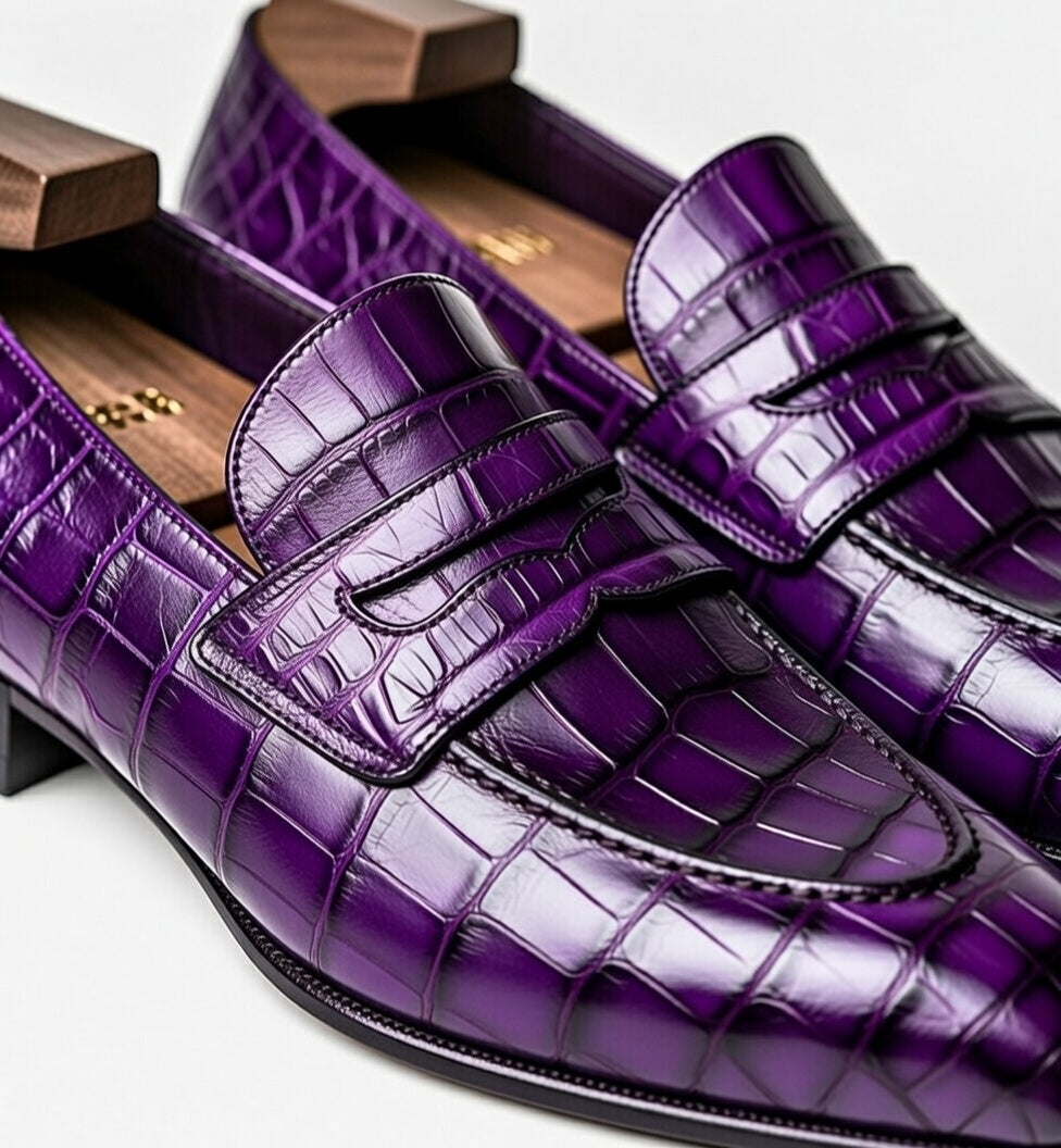 Purple crocodile-patterned loafers on a white background