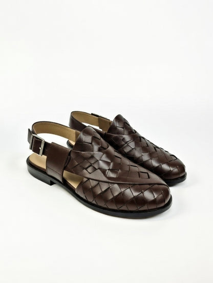 Pair of brown woven shoes on a white background