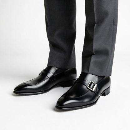 Black dress shoes with a buckle on a white background