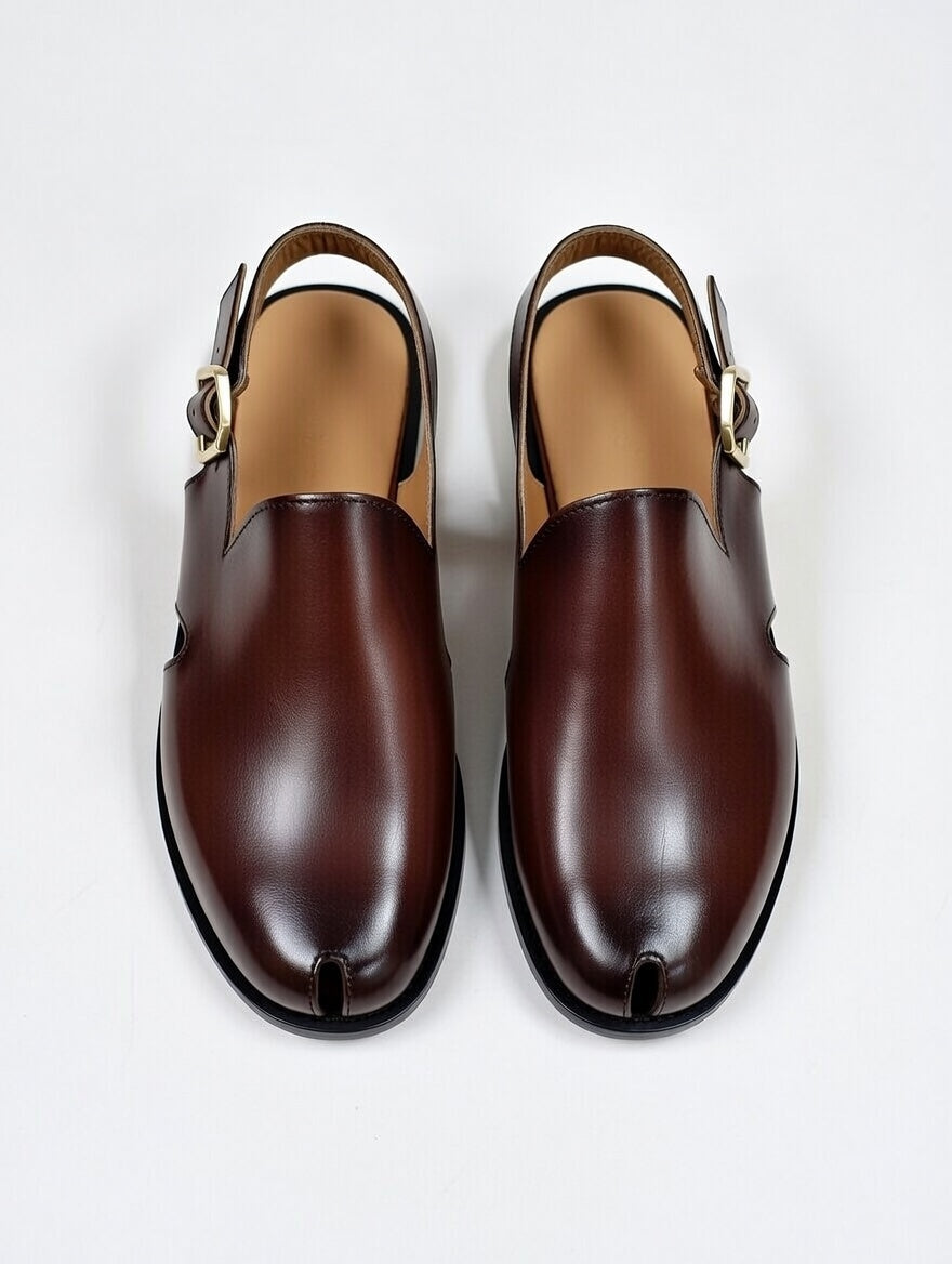 Pair of brown leather shoes with buckles on a white background