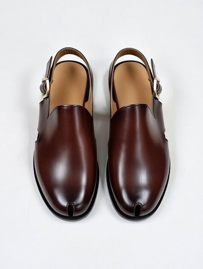 Pair of brown leather shoes with buckles on a white background