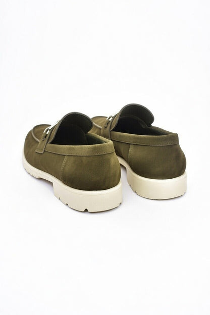 Pair of green loafers on a white background