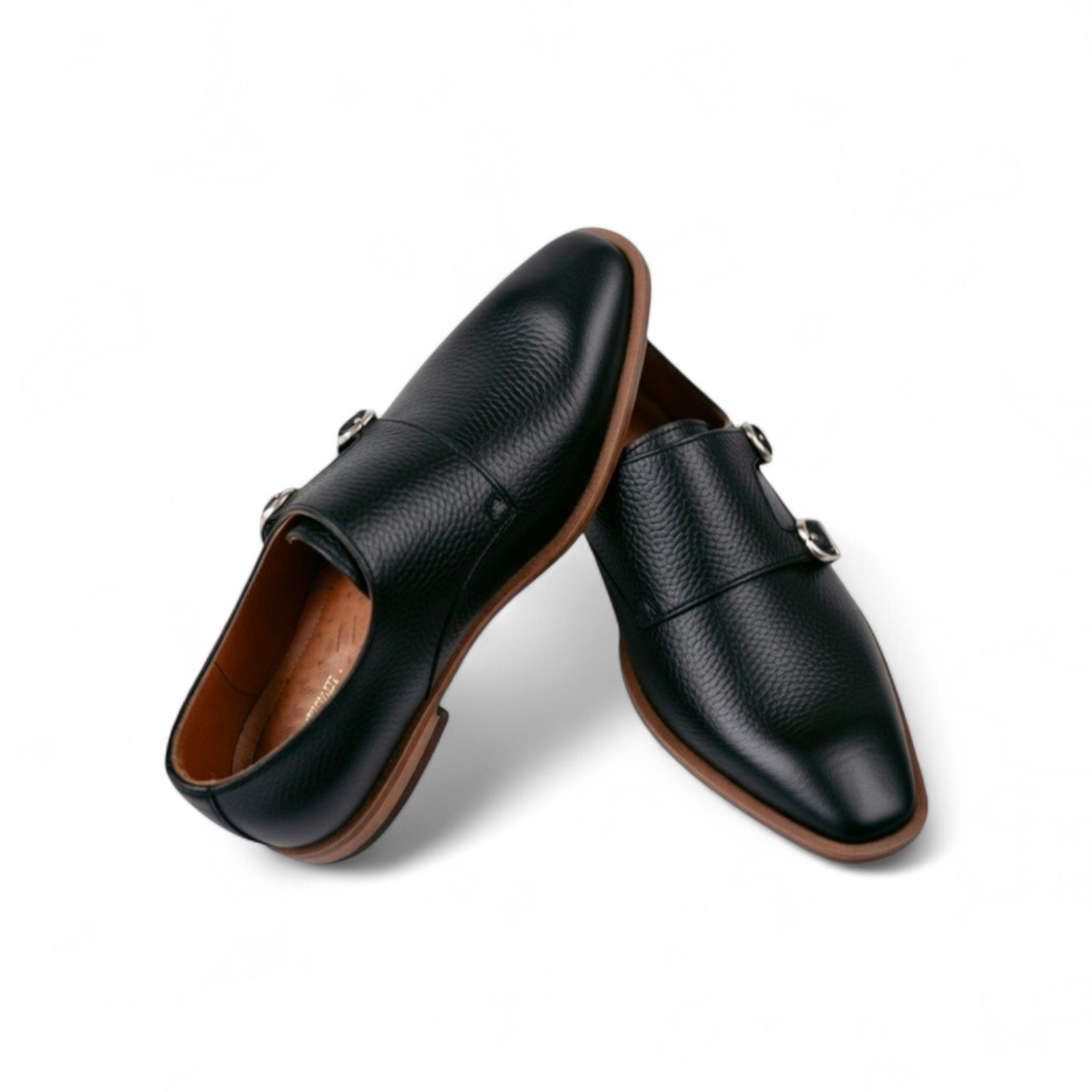 Pair of black leather shoes with brown soles on a white background