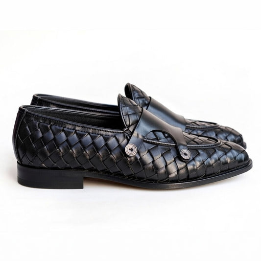 Pair of black woven loafers on a white background