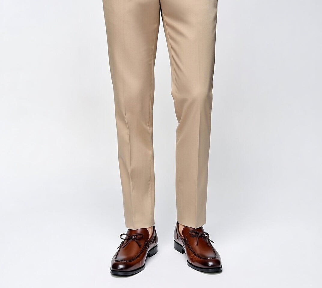 Beige pants with brown dress shoes on a white background