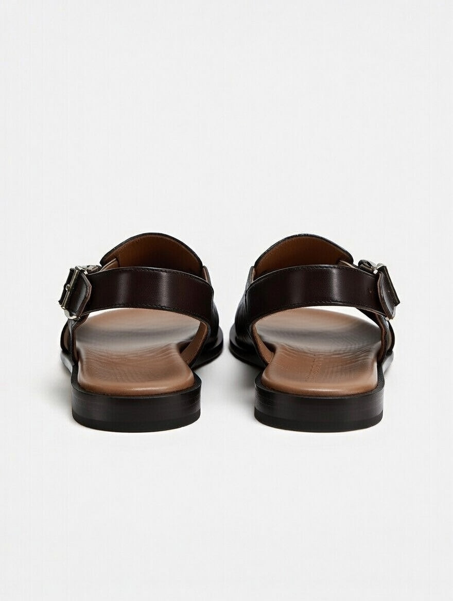 Pair of black sandals on a light gray background