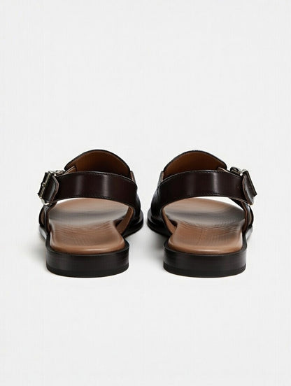 Pair of black sandals on a light gray background