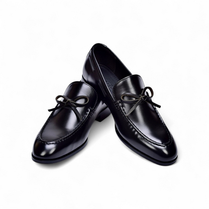 Pair of black leather shoes on a white background