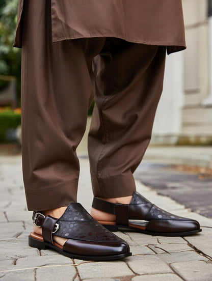 Brown pants and black shoes on a stone pavement