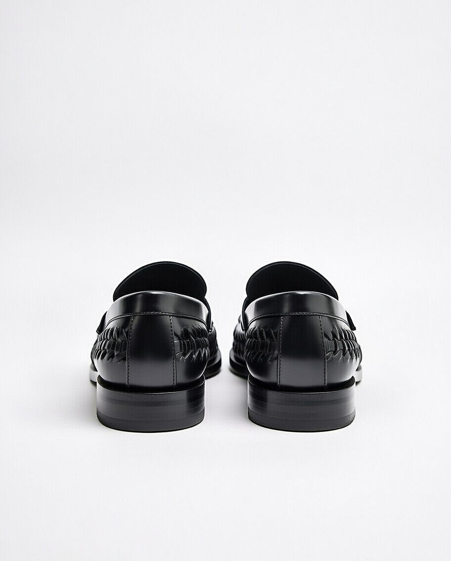 Black loafers on a white background