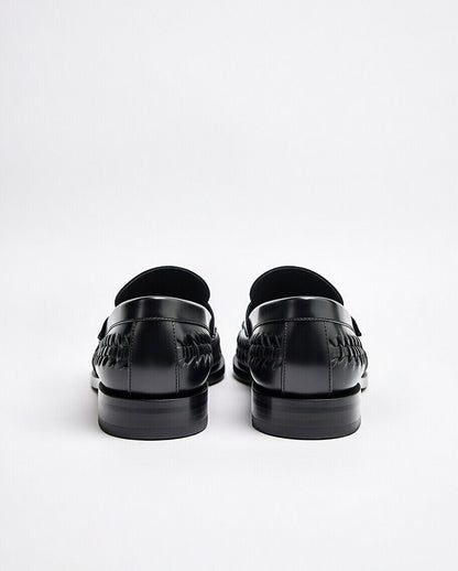 Black loafers on a white background