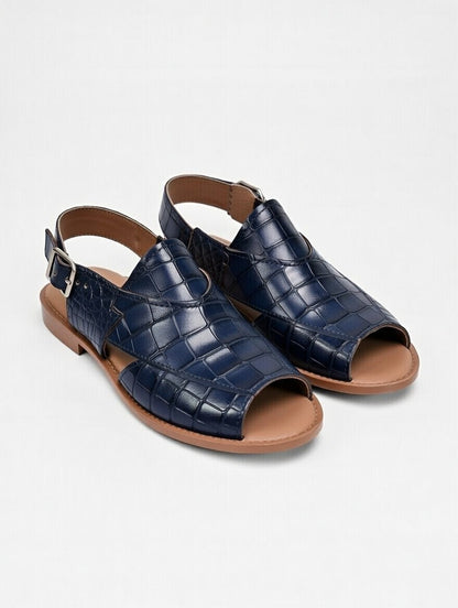Pair of navy blue crocodile-patterned sandals on a light gray background