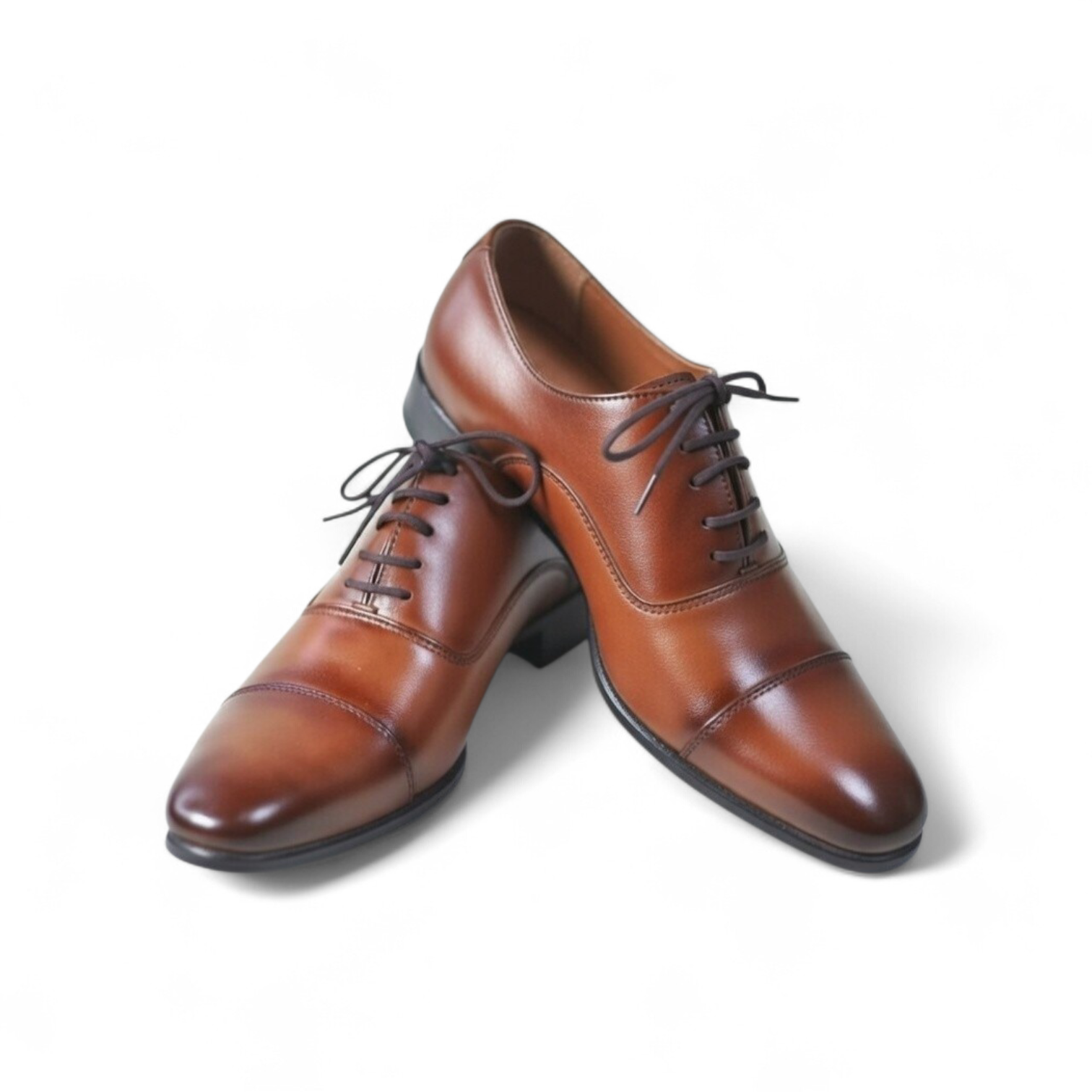 Pair of brown dress shoes on a white background
