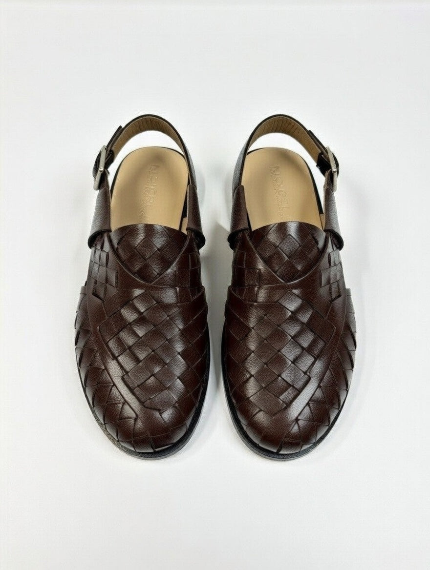 Pair of brown woven sandals on a white background