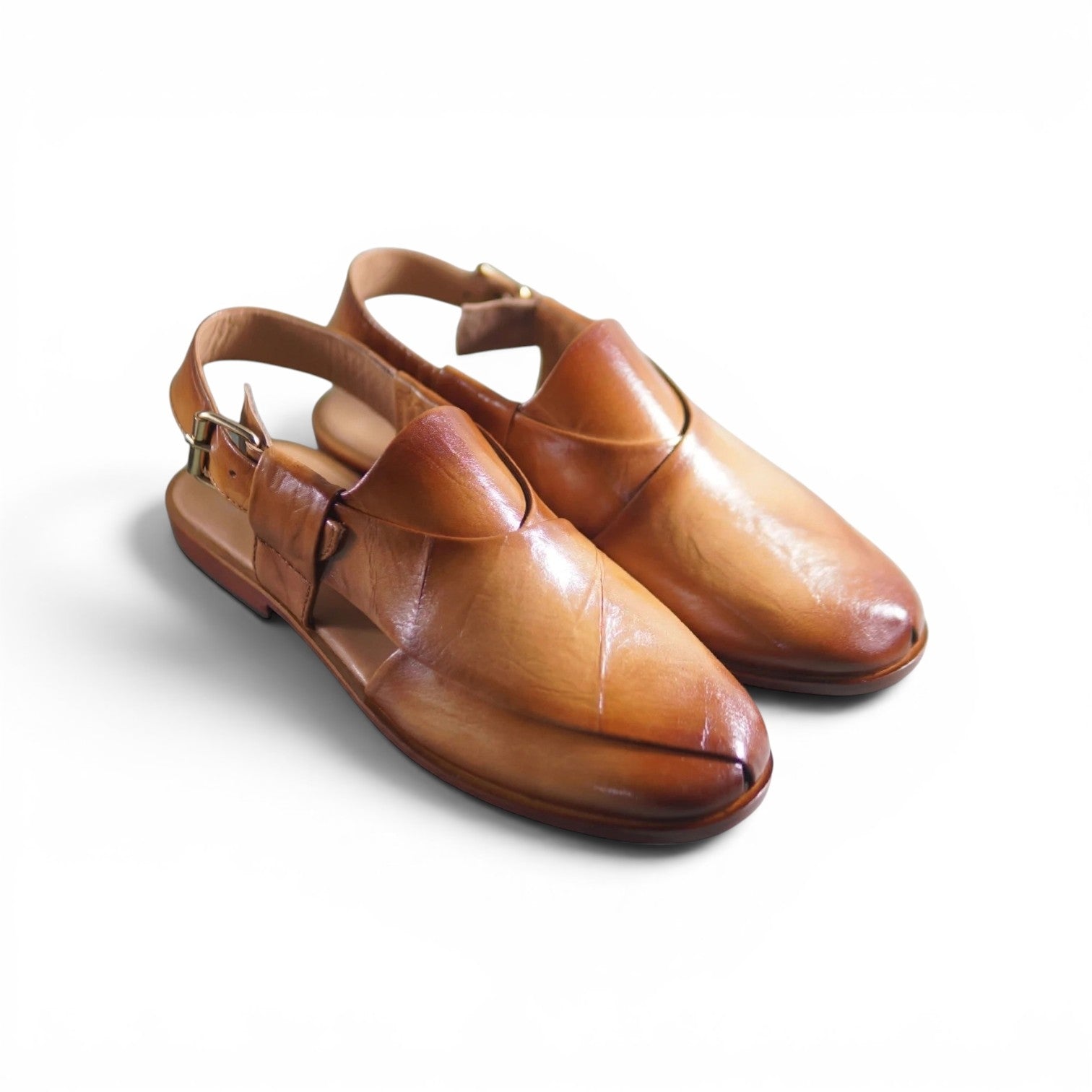 A pair of men's brown leather slip-on shoes with adjustable ankle straps and small metal buckles, photographed on a clean white background.