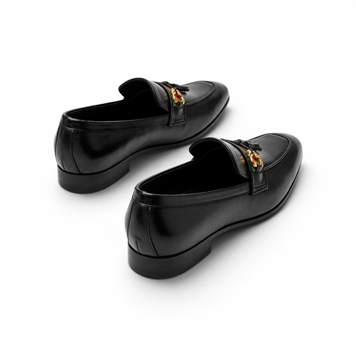 A pair of black leather penny loafers with gold-tone horsebit hardware, shown from a high-angle perspective on a clean white background.