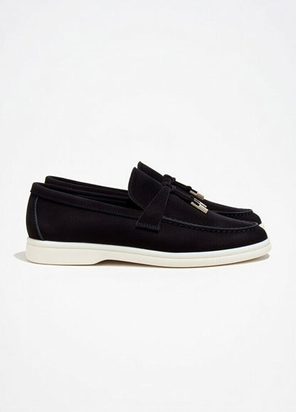Black loafers with tassels on a white background