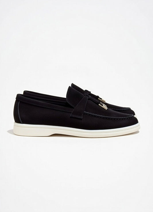 Black loafers with tassels on a white background