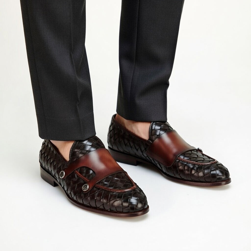 Brown woven loafers worn with black pants on a white background