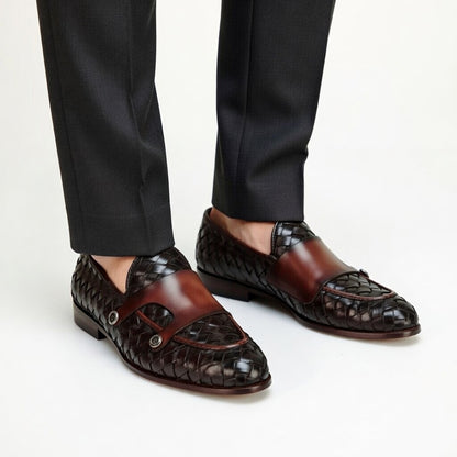Brown woven loafers worn with black pants on a white background