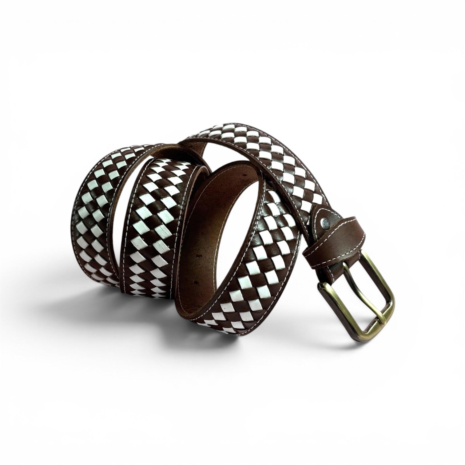 A woven leather belt with a brown and white diamond pattern, featuring a dark brown leather interior and a brass buckle, coiled on a white background.