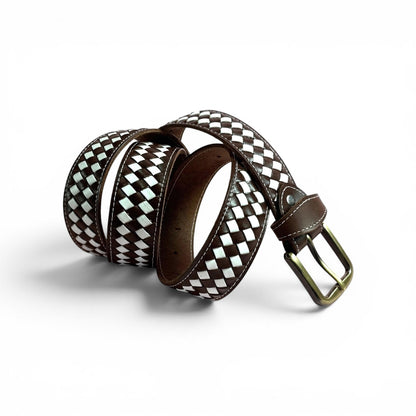 A woven leather belt with a brown and white diamond pattern, featuring a dark brown leather interior and a brass buckle, coiled on a white background.