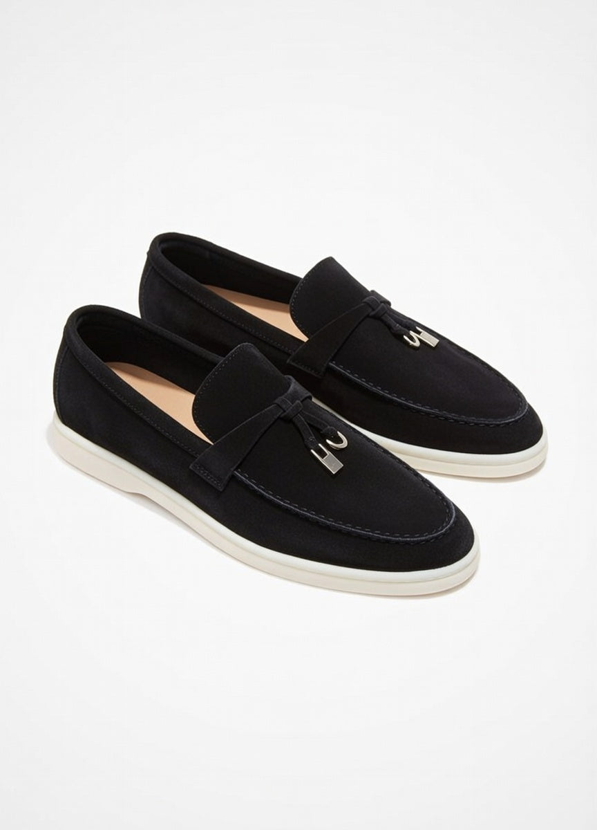 Pair of black loafers on a white background