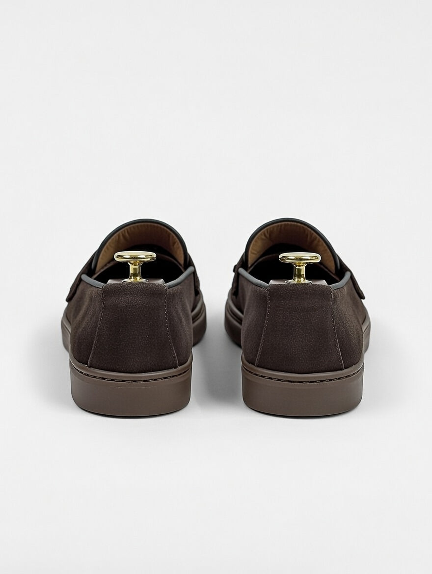 Pair of brown slip-on shoes on a white background