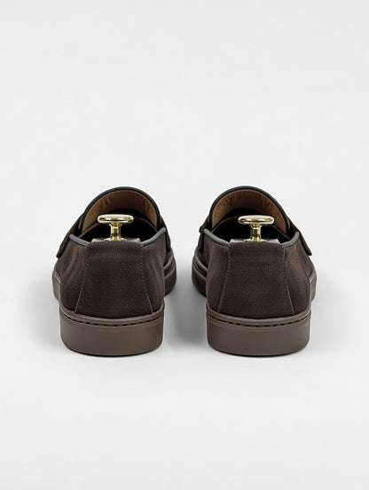 Pair of brown slip-on shoes on a white background