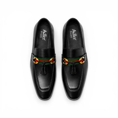 A pair of black leather loafers with a green and red web stripe and gold-tone horsebit hardware, photographed from a top-down angle on a white background. The brand name 'Asilier' is visible on the insole.