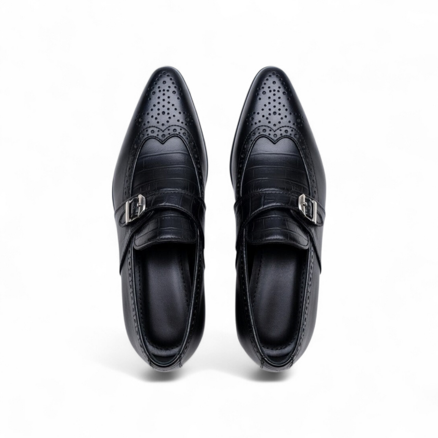 Pair of black dress shoes with decorative patterns on a white background