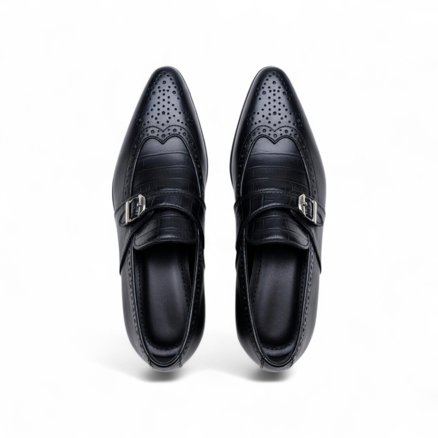 Pair of black dress shoes with decorative patterns on a white background
