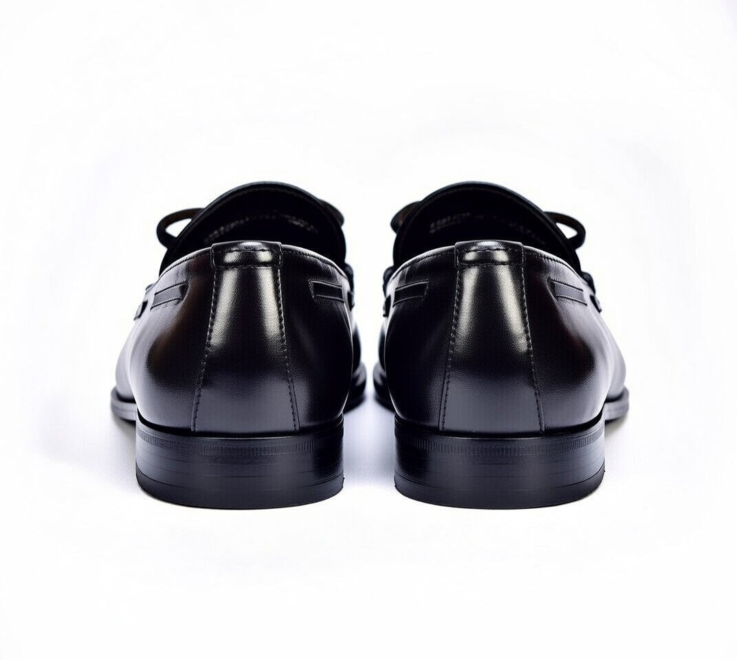 Black leather dress shoes on a white background