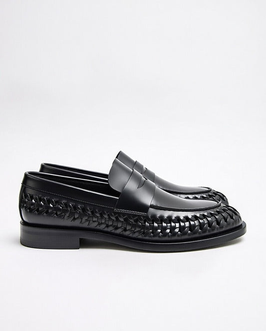 Black loafers with woven pattern on a white background
