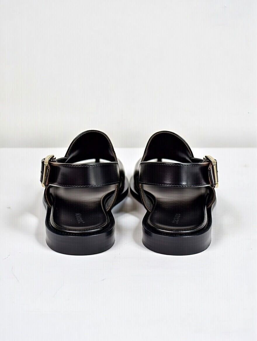 Black sandals with buckles on a white background