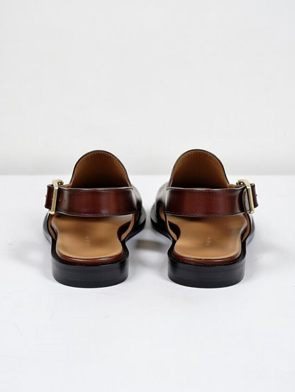 Pair of brown sandals with black soles on a white background