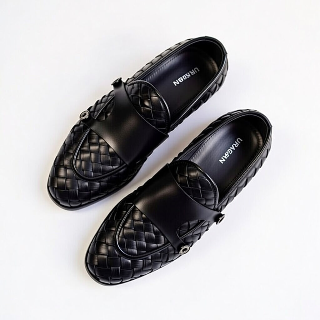 Black woven loafers on a white background