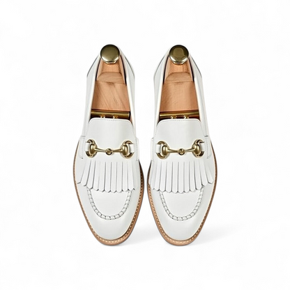 White loafers with gold accents on a white background